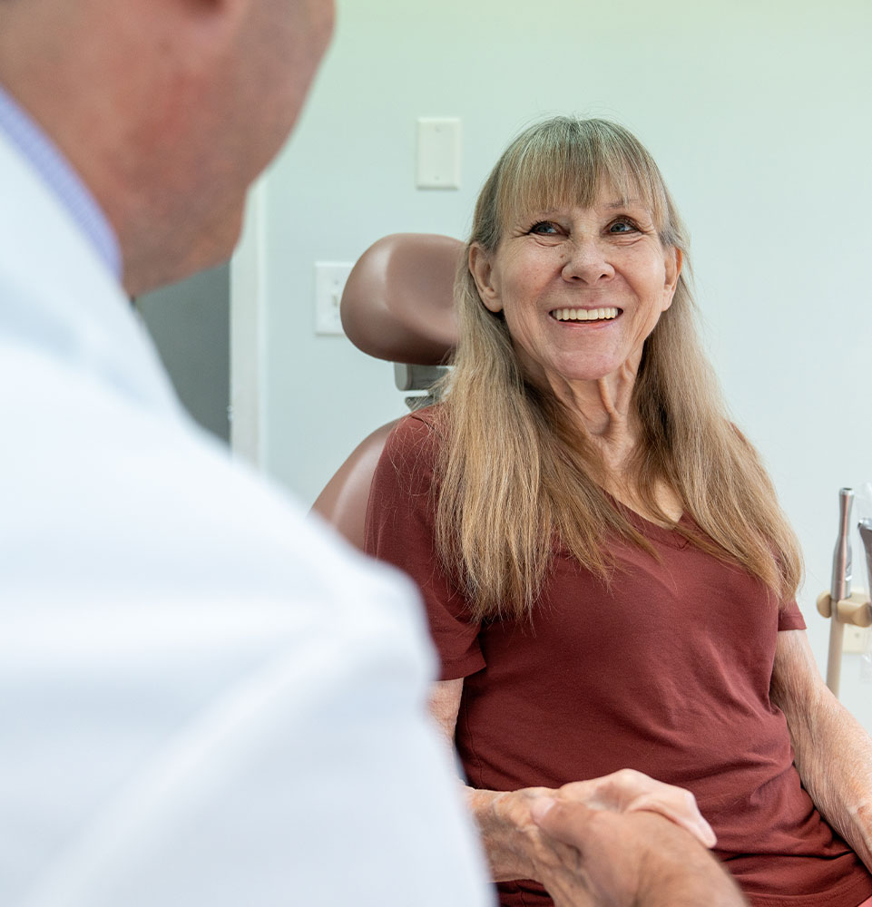 patient smiling brightly and prep and ready for dental treatment