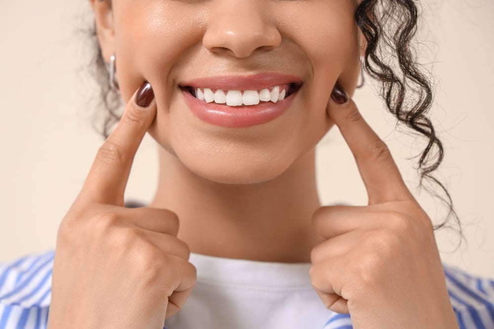 Dentist explaining crown and veneer options to a patient in modern clinic